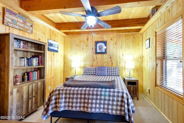 bedroom with ceiling fan, light colored carpet, beamed ceiling, and wood walls