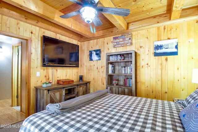 bedroom with ceiling fan, wood ceiling, wooden walls, and beamed ceiling