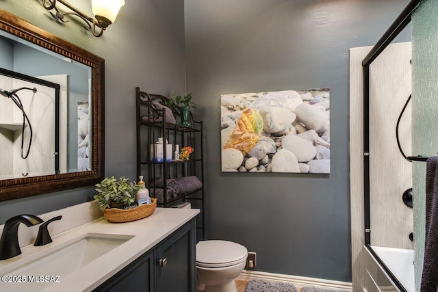 full bathroom featuring combined bath / shower with glass door, vanity, and toilet