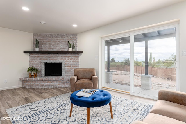 living room featuring light hardwood / wood-style flooring and a fireplace