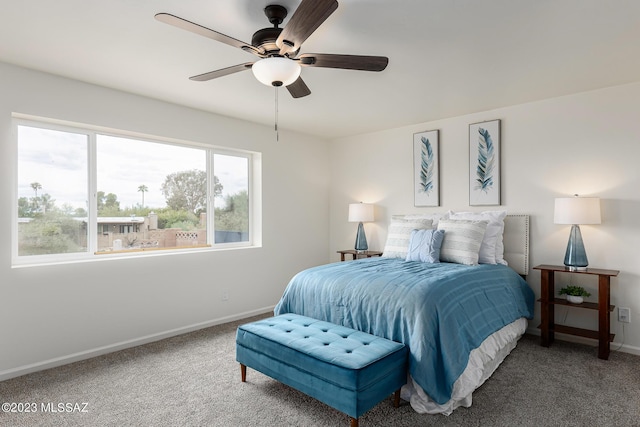 bedroom featuring ceiling fan and carpet