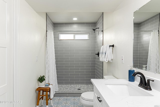 bathroom featuring walk in shower, tile patterned flooring, vanity, and toilet