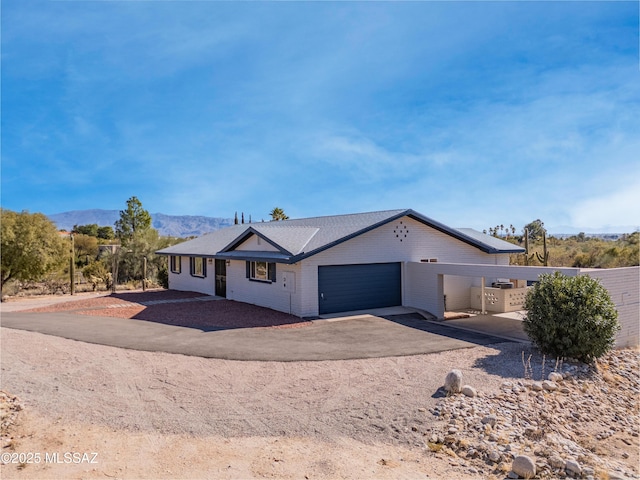 ranch-style home with a mountain view and a garage