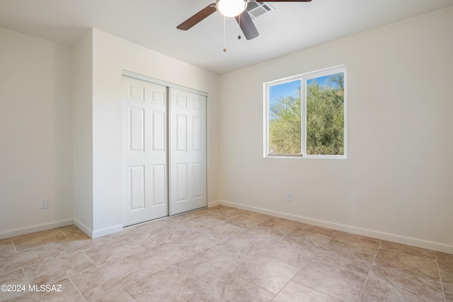 unfurnished bedroom featuring a closet and ceiling fan