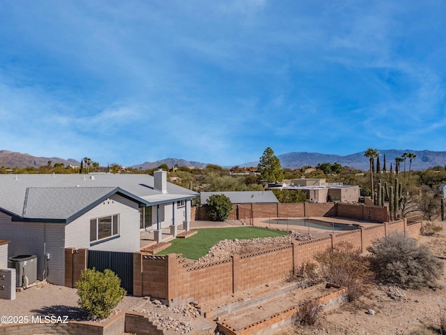 exterior space featuring central AC unit and a mountain view