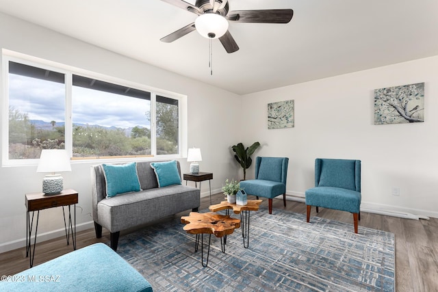 living area featuring ceiling fan and hardwood / wood-style flooring