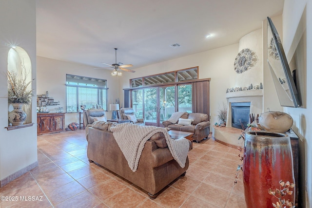 living room featuring ceiling fan and light tile patterned flooring