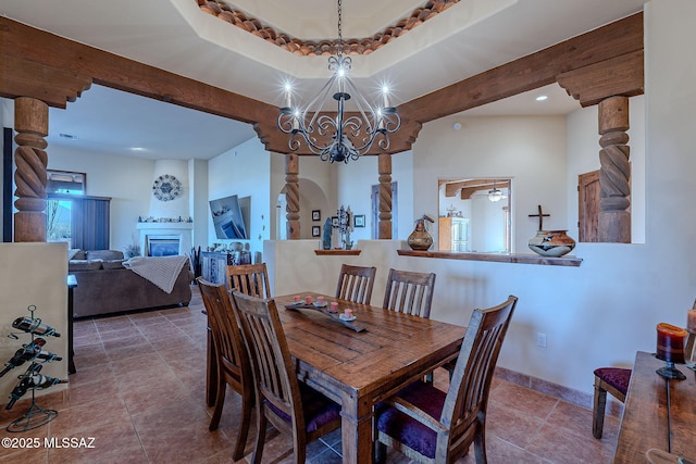 dining space featuring an inviting chandelier and a tray ceiling