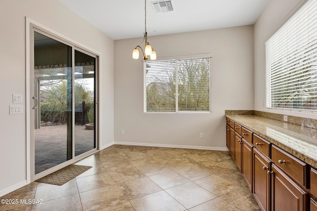 dining room with an inviting chandelier, light tile patterned floors, and plenty of natural light