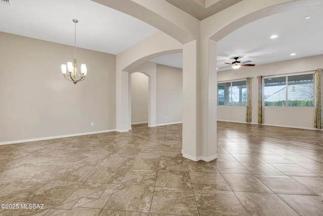 empty room featuring ceiling fan with notable chandelier