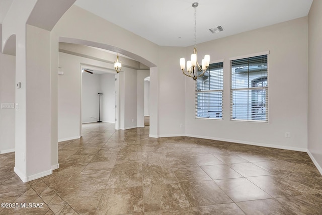 empty room featuring a notable chandelier