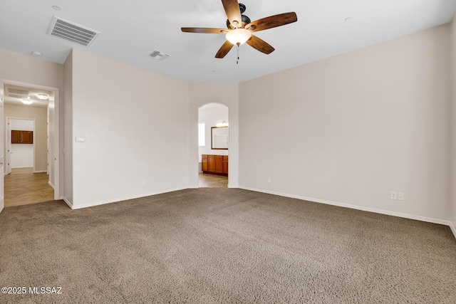 unfurnished room featuring ceiling fan and carpet