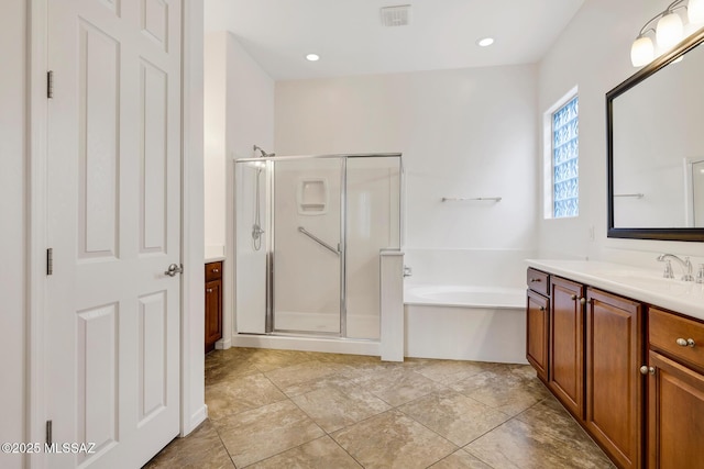 bathroom featuring plus walk in shower and vanity