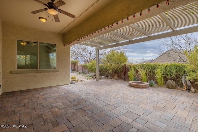 view of patio with an outdoor fire pit, ceiling fan, and a pergola