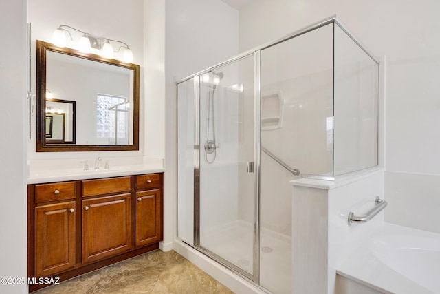 bathroom featuring vanity and independent shower and bath