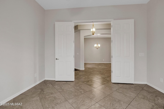 empty room featuring a notable chandelier