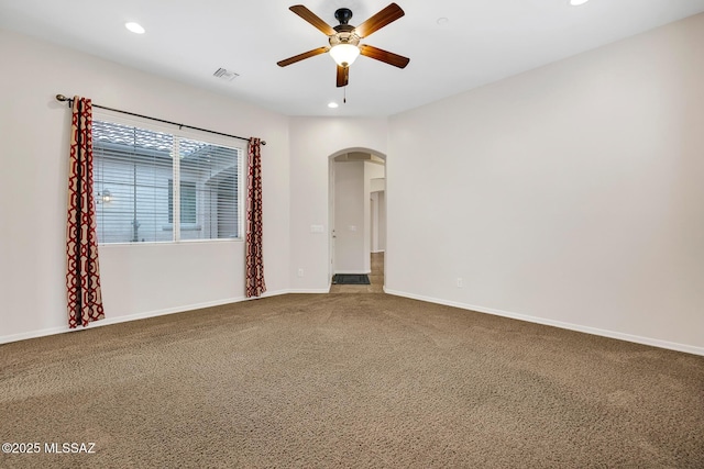 empty room featuring carpet floors and ceiling fan