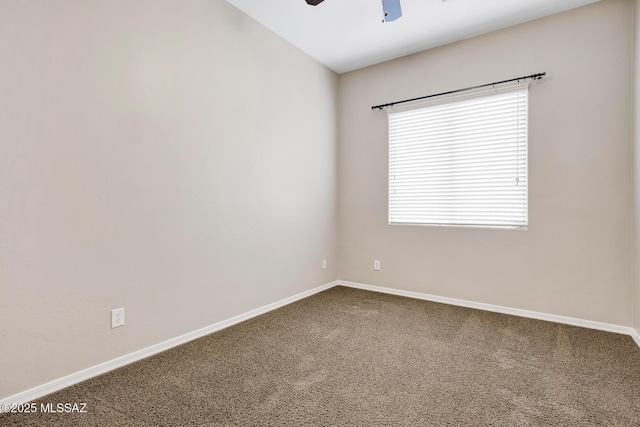 empty room featuring lofted ceiling, carpet flooring, and ceiling fan