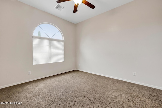 carpeted spare room featuring ceiling fan