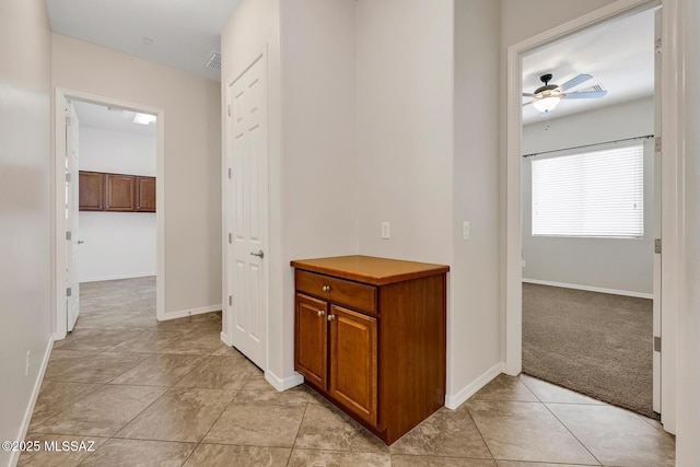 hall featuring light colored carpet