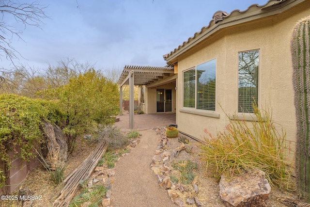 view of home's exterior featuring a patio and a pergola