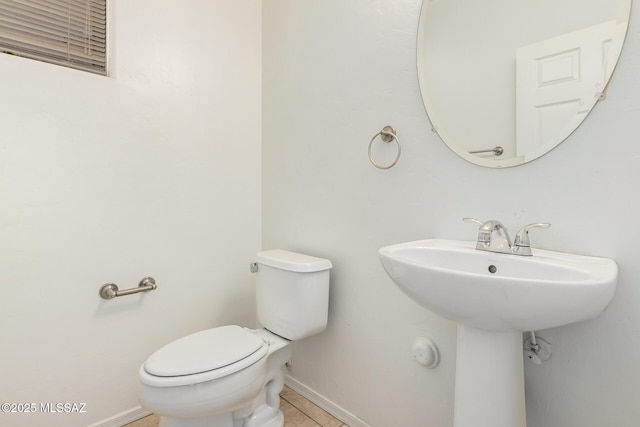 bathroom with tile patterned floors and toilet