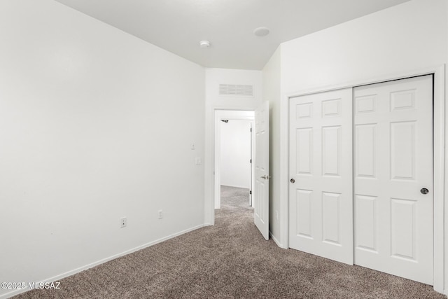 unfurnished bedroom with a closet and carpet flooring