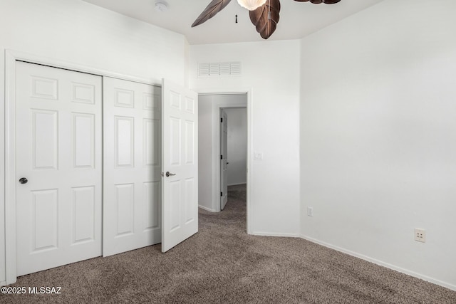 unfurnished bedroom featuring carpet floors, ceiling fan, and a closet