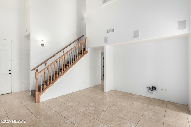 tiled entryway with a high ceiling