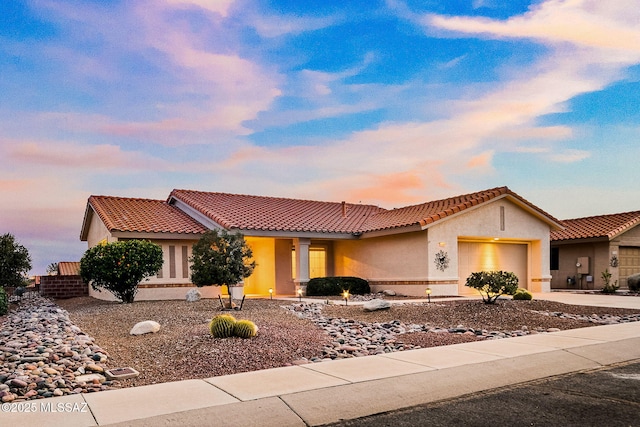 mediterranean / spanish-style house with a garage