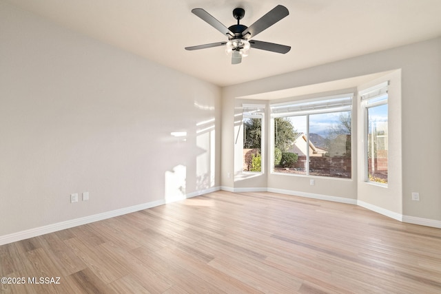 spare room with ceiling fan and light hardwood / wood-style floors