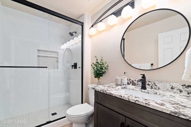 bathroom with vanity, toilet, and a shower with shower door