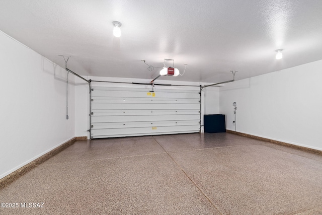 garage featuring baseboards and a garage door opener