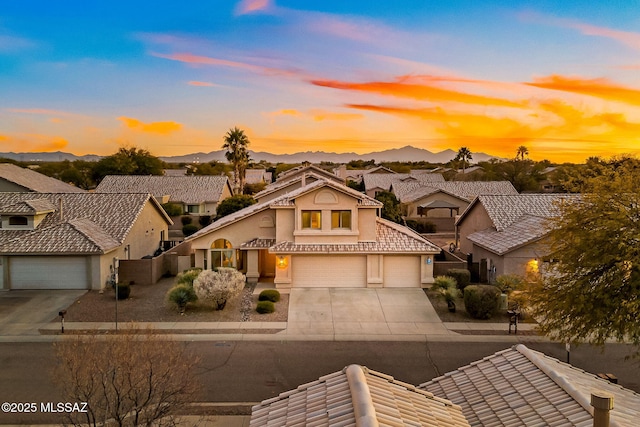 view of front of property with a garage and a mountain view