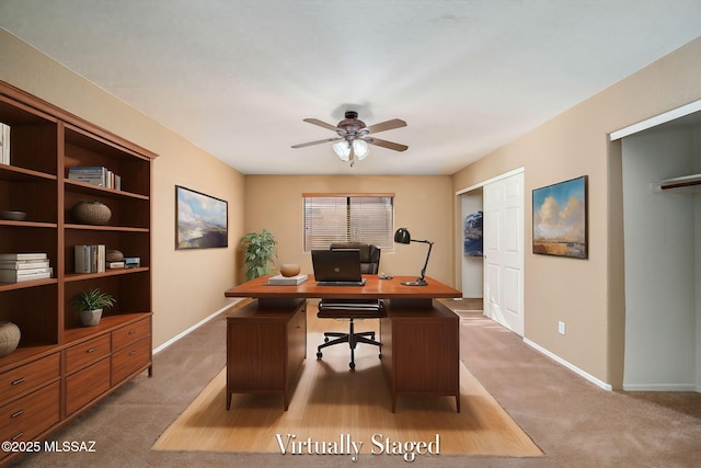 office space with ceiling fan and light carpet