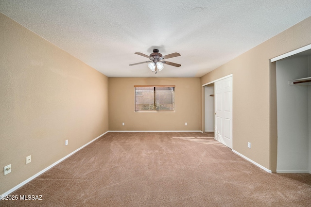 unfurnished bedroom featuring light carpet, ceiling fan, and a textured ceiling