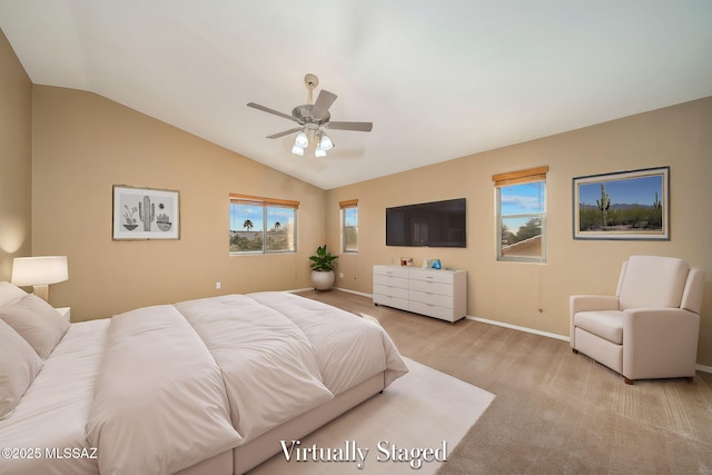 carpeted bedroom with multiple windows, vaulted ceiling, and ceiling fan