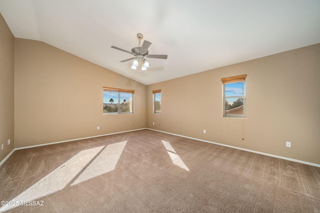 empty room with lofted ceiling, carpet, and ceiling fan