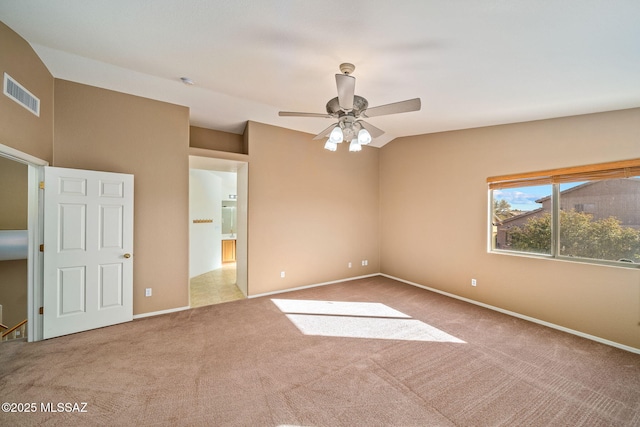 carpeted empty room with lofted ceiling and ceiling fan