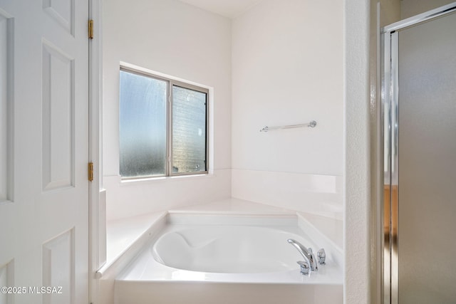 bathroom featuring separate shower and tub