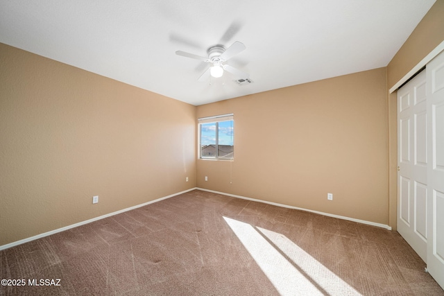 unfurnished bedroom with ceiling fan and carpet