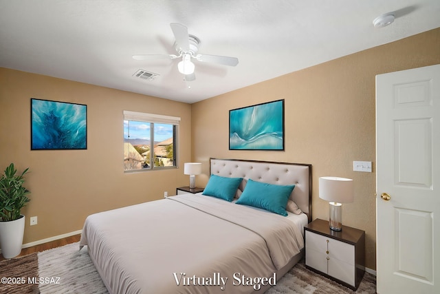 bedroom with wood-type flooring and ceiling fan