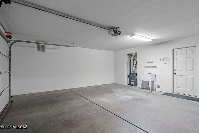 garage with a garage door opener and sink