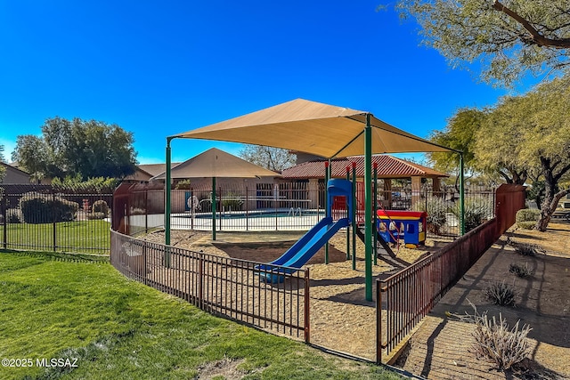 view of jungle gym featuring a lawn