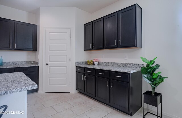 kitchen with light stone counters, sink, and appliances with stainless steel finishes