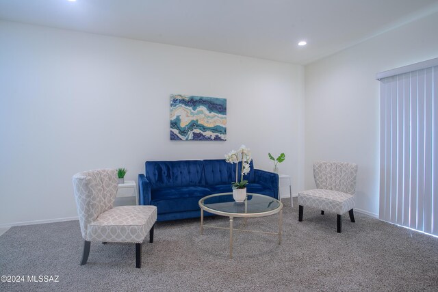 living room with carpet and an inviting chandelier