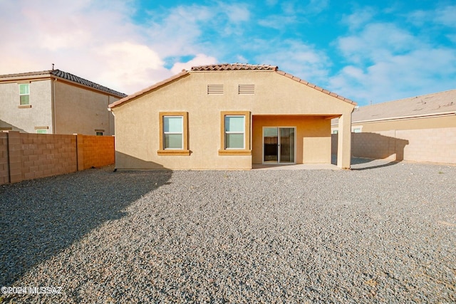 rear view of property featuring a patio area