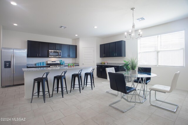 kitchen with light stone countertops, sink, stainless steel appliances, and light tile patterned flooring