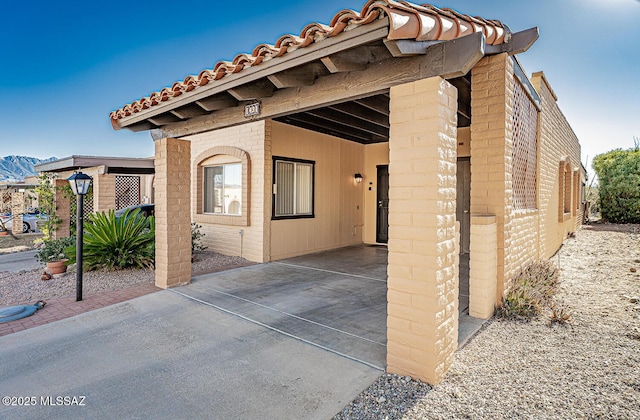 exterior space with a mountain view and a carport