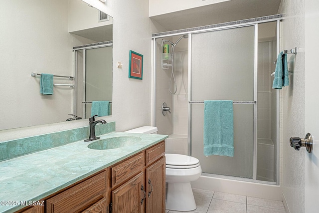 bathroom featuring walk in shower, tile patterned flooring, vanity, and toilet